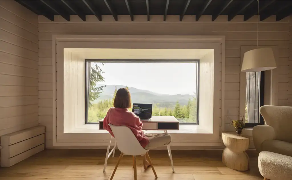 Mujer en vivienda contemplando naturaleza